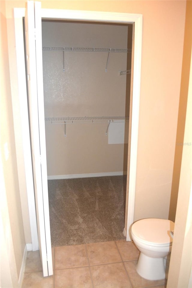 bathroom with tile patterned flooring and toilet