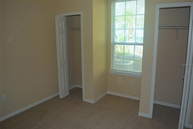 unfurnished bedroom featuring light colored carpet