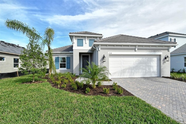 view of front of property with a front yard and a garage