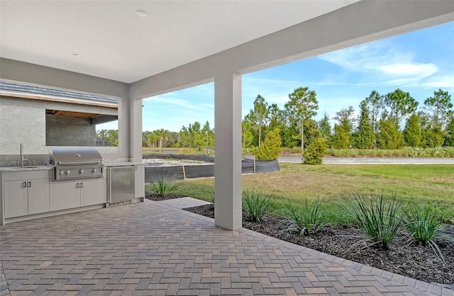 view of patio / terrace featuring area for grilling, sink, and grilling area