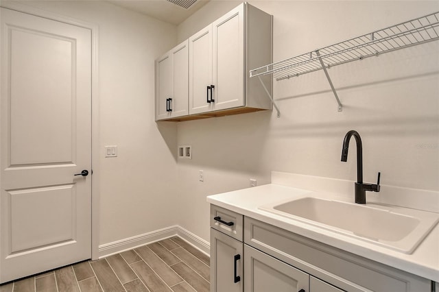 laundry area with cabinets, sink, and washer hookup