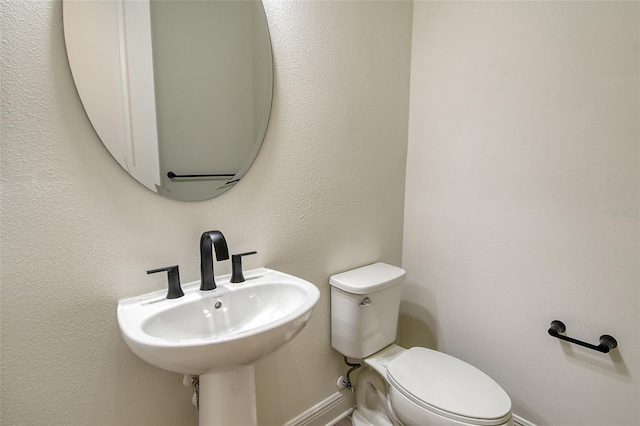 bathroom featuring toilet and sink