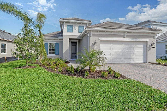 view of front of property featuring a garage and a front yard