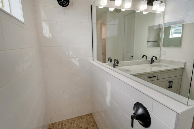 bathroom featuring vanity and tiled shower