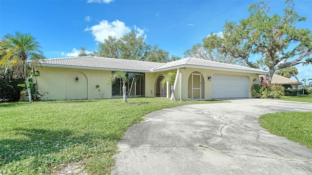 view of front of home featuring a front yard and a garage