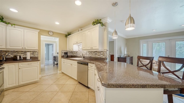 kitchen with white cabinetry, appliances with stainless steel finishes, ornamental molding, and hanging light fixtures