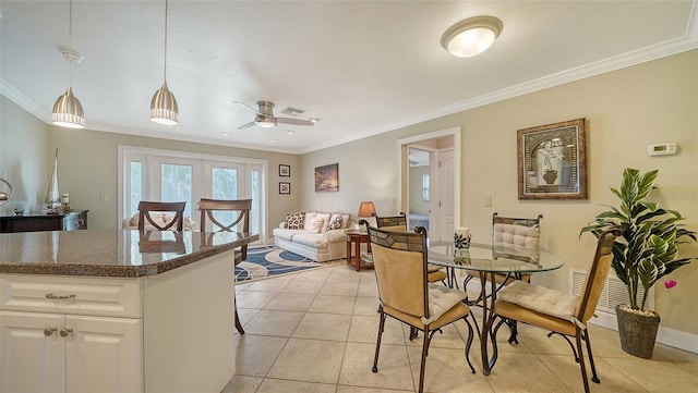 dining area featuring french doors, light tile patterned floors, ceiling fan, and crown molding