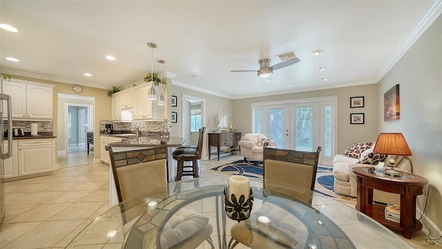 dining space with ornamental molding, light tile patterned floors, and ceiling fan