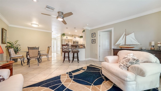 living room with light tile patterned flooring, ceiling fan, and crown molding