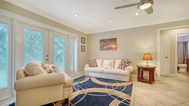 tiled living room with a wealth of natural light, crown molding, and french doors