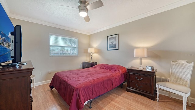 bedroom with light hardwood / wood-style floors, ceiling fan, a textured ceiling, and crown molding