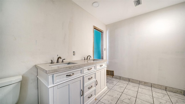 bathroom with vanity and toilet