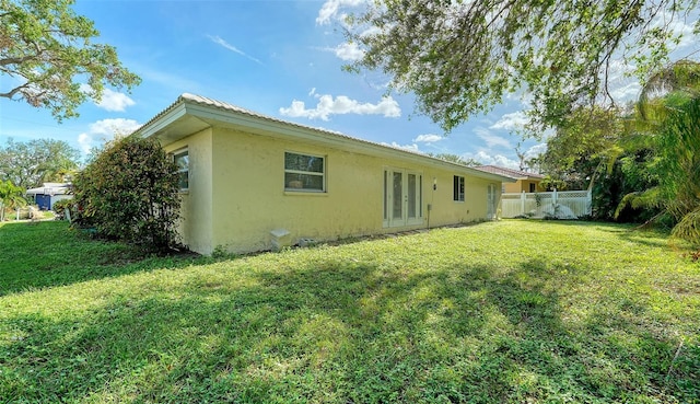 back of property featuring a lawn