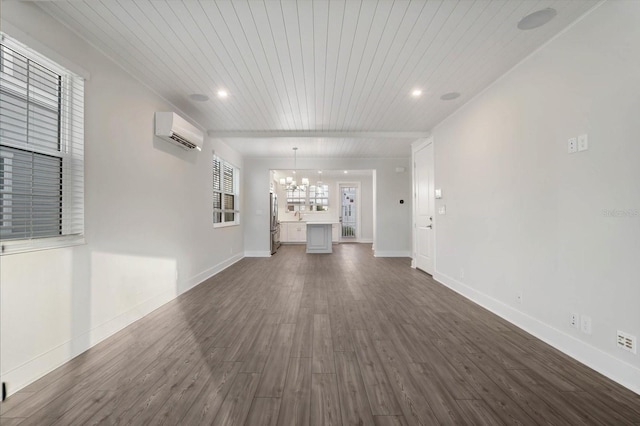 unfurnished living room featuring a wall mounted air conditioner, dark wood-type flooring, and a notable chandelier