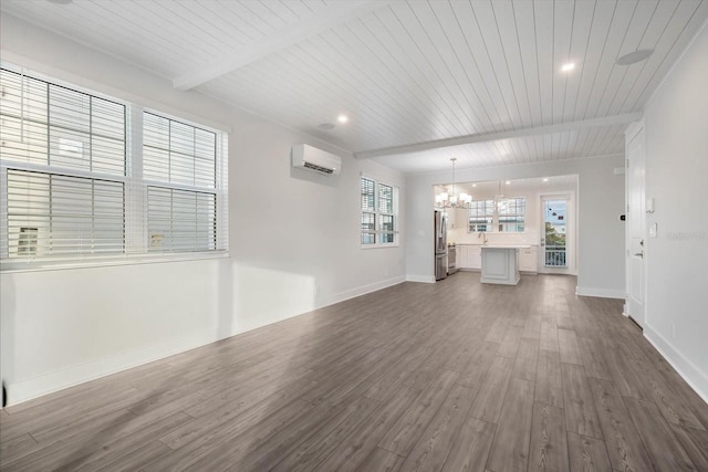 unfurnished living room featuring wood ceiling, a healthy amount of sunlight, dark wood-type flooring, an AC wall unit, and a notable chandelier