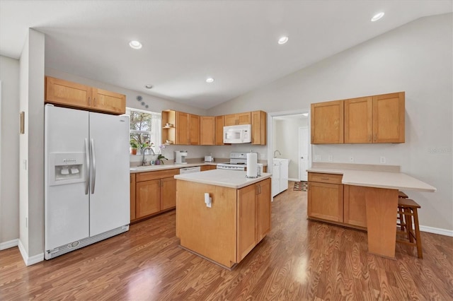 kitchen with white appliances, wood finished floors, open shelves, vaulted ceiling, and light countertops
