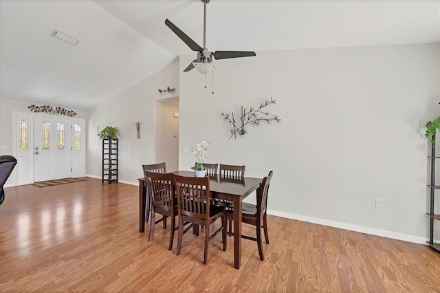 dining space featuring light wood-type flooring, ceiling fan, and high vaulted ceiling