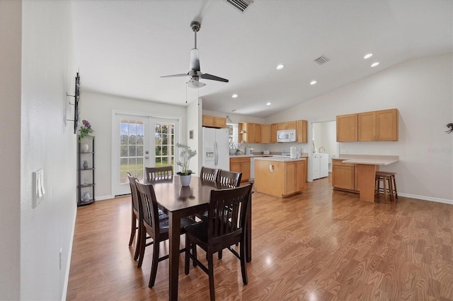 dining area featuring vaulted ceiling, ceiling fan, light hardwood / wood-style flooring, and french doors