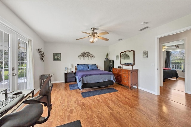 bedroom featuring french doors, access to exterior, light wood-type flooring, visible vents, and baseboards
