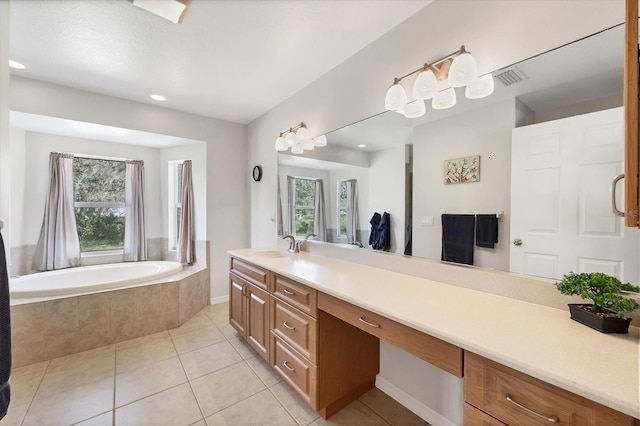 bathroom with vanity, tile patterned floors, and a relaxing tiled tub