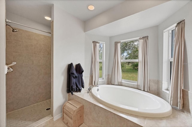 bathroom featuring tiled shower, a garden tub, and tile patterned flooring