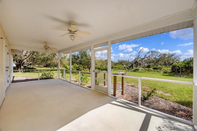 unfurnished sunroom featuring a ceiling fan
