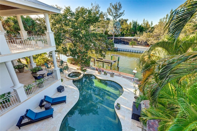 view of pool featuring a water view and a patio area