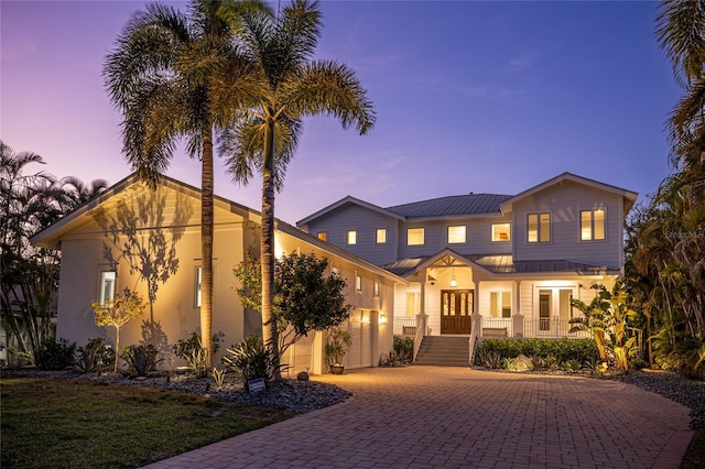 1243 Starboard Ln, Sarasota, FL 34242 - view of front of property featuring french doors, driveway, a standing seam roof, metal roof, and stucco siding