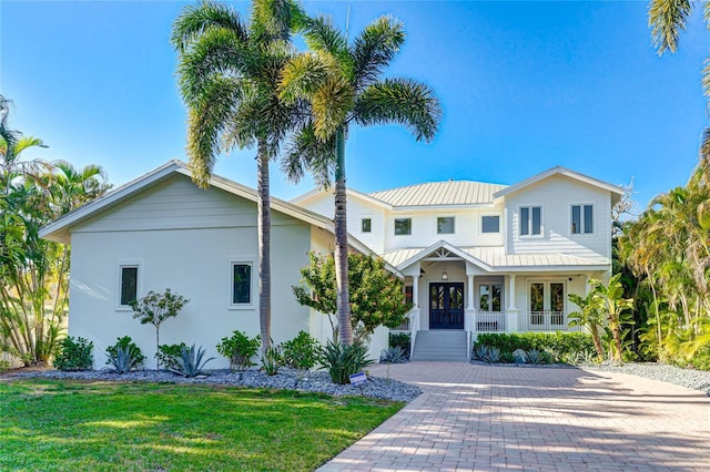 view of front of home featuring a front lawn and french doors