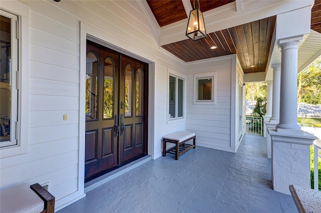 view of exterior entry with covered porch