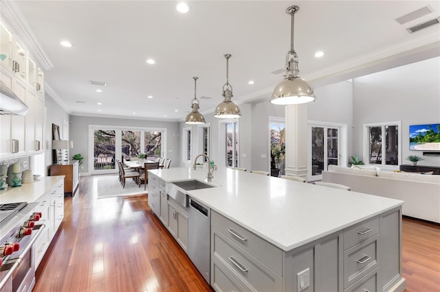 kitchen featuring sink, stainless steel dishwasher, gray cabinets, and a large island