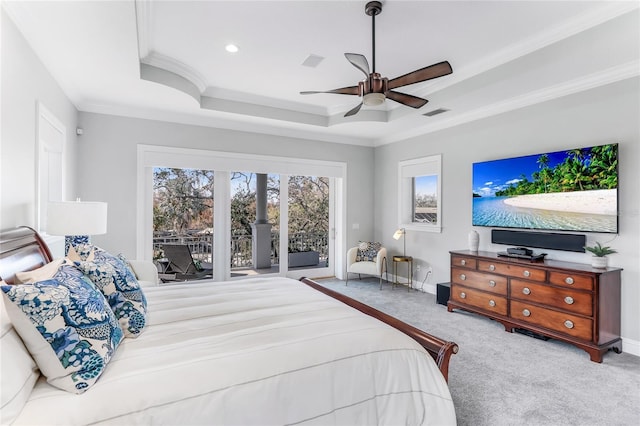 bedroom with ceiling fan, light colored carpet, access to outside, a tray ceiling, and ornamental molding