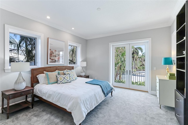 carpeted bedroom with crown molding, french doors, and access to outside