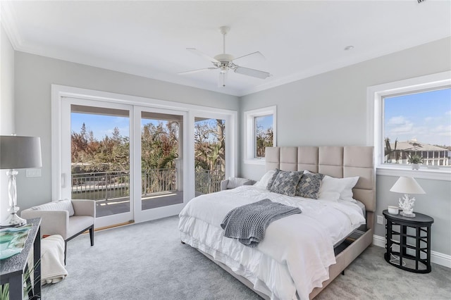 bedroom featuring ceiling fan, multiple windows, and access to outside