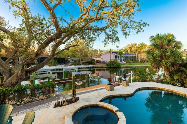 view of pool with an in ground hot tub