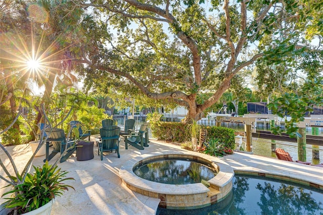 view of swimming pool with an in ground hot tub and a patio