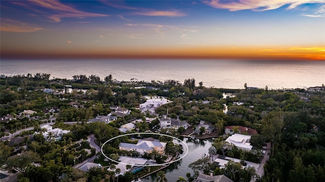 aerial view at dusk with a water view