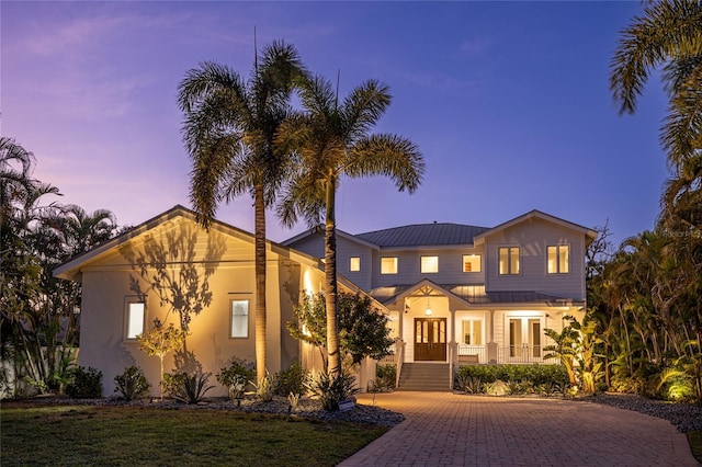 view of front of house with covered porch and french doors