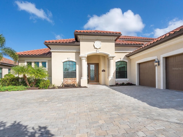 mediterranean / spanish house with a garage