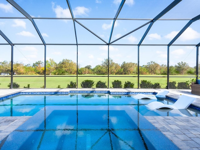 view of swimming pool with a lanai and a patio