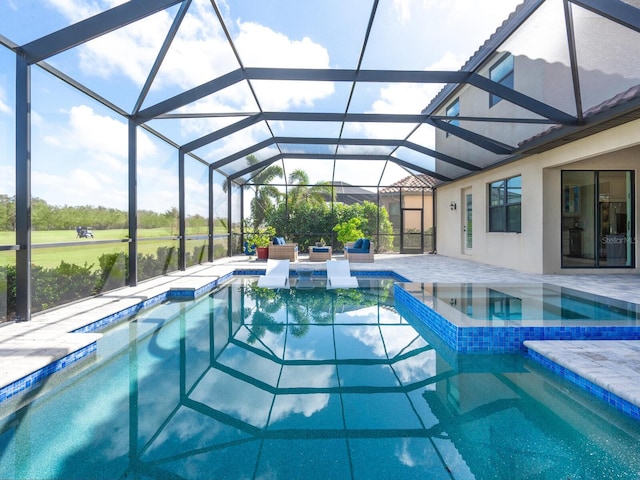 view of pool with an in ground hot tub, a lanai, and a patio area