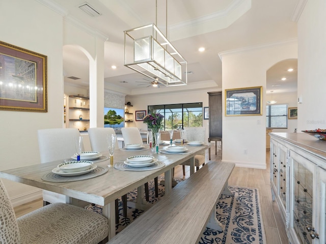 dining area featuring crown molding and light wood-type flooring