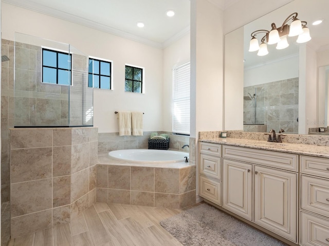 bathroom with vanity, ornamental molding, and shower with separate bathtub