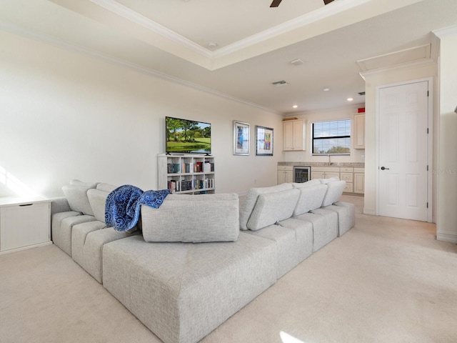 living room with light carpet, sink, wine cooler, and ornamental molding