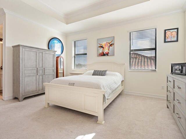 bedroom featuring multiple windows, ornamental molding, a raised ceiling, and light carpet