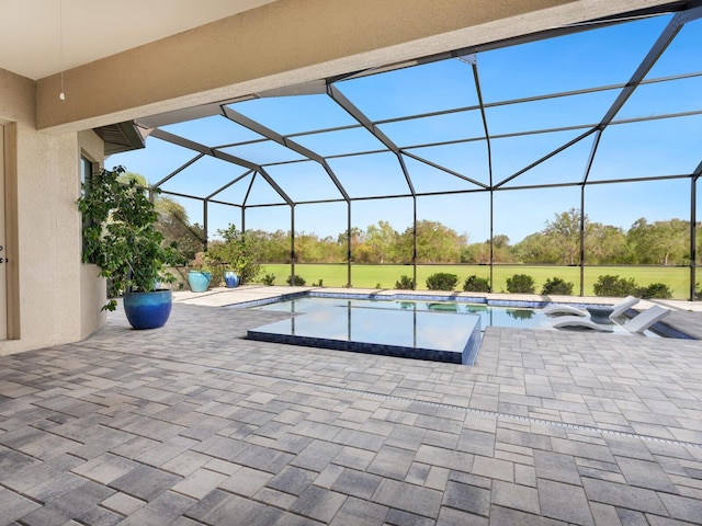 view of swimming pool featuring a lanai and a patio area