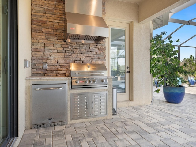 view of patio featuring a grill, a lanai, and an outdoor kitchen