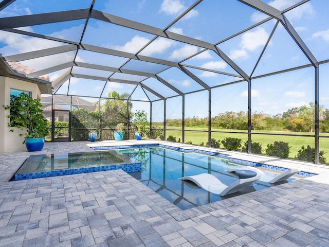 view of swimming pool with an in ground hot tub, a lanai, and a patio