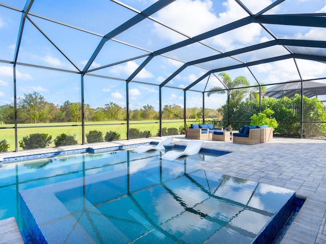 view of swimming pool with outdoor lounge area, a lanai, and a patio area