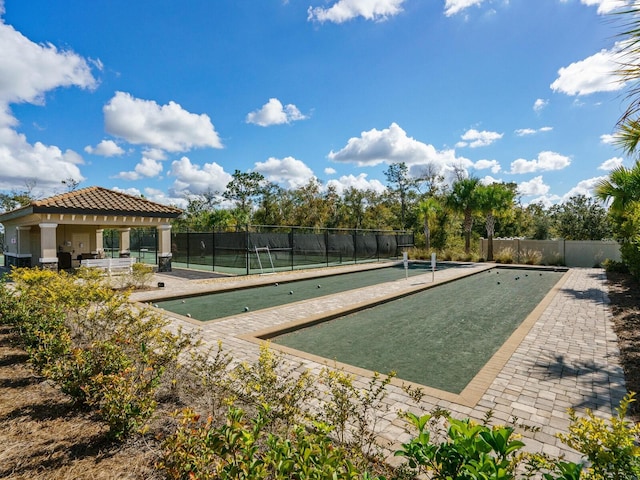 surrounding community with a gazebo and tennis court